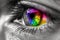 A detailed close-up of an eye with vibrant rainbow colors, creating a mesmerizing and captivating visual experience