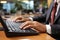 Detailed close-up of hands typing on laptop keyboard with intense focus and high-quality execution