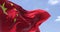 Detailed close up of the national flag of China waving in the wind on a clear day