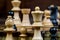 Detailed close up of white chess figures - white bishop, pawn and queen, black pawn