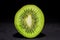 Detailed cross section of a fresh illuminated kiwi fruit cut in half