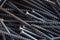 Detailed dark background and texture full frame of pile metal steel nails for construction of carpenter