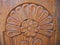 Detailed hand carved flower on traditional hungarian oak wood gate pylon .