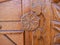 Detailed hand carved flower on traditional hungarian oak wood gate pylon .