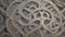 A detailed, intricate Celtic knot pattern in a metallic finish.