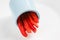 Detailed isolated copy space close up food shot of a pile of slices of fresh wet sweet red bell pepper in a blue round clay