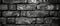 Detailed monochrome close-up of cracked paint on brickwork, illustrating the intricate patterns of decay and the