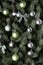 Detailed photo of the Christmas tree decorated with gifts, bright colored spherical toys, ribbons and garlands close-up. Abstract