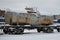 Detailed photo of snowy frozen railway freight car. A fragment of the component parts of the freight car on the railroad in snowy