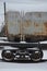 Detailed photo of snowy frozen railway freight car. A fragment of the component parts of the freight car on the railroad in snowy