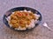 Detailed Picture of typical indian food hot lamb curry with rice and chopped chili served on the deep plate