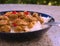 Detailed Picture of typical indian food hot lamb curry with rice and chopped chili served on the deep plate