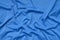 Detailed polyester blue fabric texture with many folds