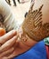 Detailed process of applying intricate pattern Henna on hand