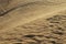 Detailed sand Photograph of Abu Dhabi desert with car tires marks in the sand