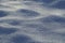 Detailed semi-blurred texture of white crystal clear snow on an early winter morning. Snow beautiful background