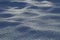 Detailed semi-blurred texture of white crystal clear snow on an early winter morning. Snow beautiful background