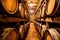a detailed shot of wine barrels stacked in a resort cellar