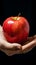 Detailed shot Womans hand grasping an apple, highlighting its vibrant presence