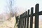 Detailed side view of old wooden fence during sunny spring day in countryside