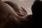 Detailed texture of human skin. Close up shot of young african-american male body like landscape with the sky background