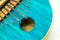 Detailed view from above of blue African kalimba made of pumpkin on a white background. Traditional African music concept