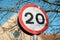 Detailed view of a British 20MPH road speed seen near a pedestrian zone.