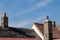 Detailed view of built chimneys seen atop a very old cottage during midday