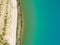 Detailed view of the edge of a rainwater retention basin with turquoise coloured water, abstract effect through vertical angle of