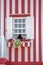 Detailed view of front facade window with flowers of typical Costa Nova beach house