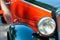 Detailed view of a historic vehicle with free headlights, red bonnet and black shiny wings, Oldtimer-Festival