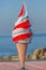 Detailed view of ice cream cone in plastic, commercial icon for ice cream seller, sea as background