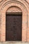 Detailed view of massive metal entrance door of the Church of St. George in Bila Tserkva, Ukraine. Wall with red brick