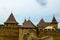 Detailed view of the old wooden tile roof in ancient castle. Close-up view of high stone walls and massive towers.