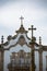 Detailed view at the pillory with a cross and the pediment cornice at the Church of Mercy, baroque style monument, architectural