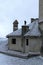 Detailed view of red tile roof in the snow. Ancient Bran Castle, also called Dracula`s Castle.