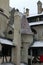 Detailed view of roof covered by red tile in the snow with several chimneys. Ancient Bran Castle, also called Dracula`s Castle.