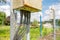 Detailed view of a rusting electrical junction box located at a boating marina.