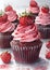 Detailed watercolor illustration of a cupcake topped with strawberries and pink frosting surrounded by fresh