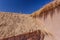 Details of of an ancien straw hatched  church roof with white walls  . Taken during springtime at Socaire at Los Flamencos