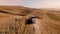 Details of autumn harvest. Aerial view of combine harvesting over the hills