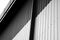 Details of black and white corrugated iron sheet used as a facade of a warehouse or factory. Texture of a seamless