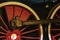 Details of bright red wheels, fragment of old locomotive closeup. Absract vintage background