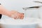 details of caucasian woman washing hands with soap and tap water