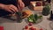 Details: Chef's hands holding a jar filled with fresh organic red and green spicy chili peppers, prepared for