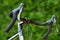 Details. Close up shot of handlebar of road bicycle on green nature background