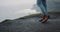 Details closeup tourist walking to the shore of the Cliffs wearing a brown boots, he stopped beside the shore , amazing