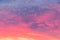 Details of clouds at sunset with dark orange, pink, and blueish purple tones