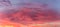 Details of clouds at sunset with dark orange, pink, and blueish purple tones