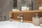 Details of corner with water tap sink with faucet with soap and shampoo dispensers in expensive bathroom in rustic eco style